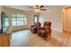 Bright living room featuring hardwood floors, large windows, and comfortable seating at 1825 San Mateo Dr, Dunedin, FL 34698