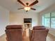 Relaxing living room with two leather recliners, a large TV, and hardwood floors at 1825 San Mateo Dr, Dunedin, FL 34698