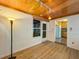 Sunroom with kitchen access and wood-look flooring at 1825 San Mateo Dr, Dunedin, FL 34698
