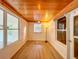 Sunroom featuring wood ceiling and large windows at 1825 San Mateo Dr, Dunedin, FL 34698