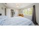Relaxing bedroom with striped bedding and large window at 1855 Bough Ave # B, Clearwater, FL 33760