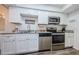 Modern kitchen with white cabinets and stainless steel appliances at 1855 Bough Ave # B, Clearwater, FL 33760