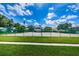 Well-maintained tennis court with grassy surroundings at 1855 Bough Ave # B, Clearwater, FL 33760