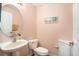 Clean and modern half bathroom with pedestal sink and toilet at 2135 Park Crescent Dr, Land O Lakes, FL 34639