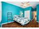Bedroom with teal walls, wood flooring, and a ceiling fan at 2135 Park Crescent Dr, Land O Lakes, FL 34639