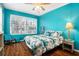 Bedroom with teal walls, wood flooring, and a ceiling fan at 2135 Park Crescent Dr, Land O Lakes, FL 34639