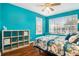 Bedroom with teal walls, wood flooring, and a ceiling fan at 2135 Park Crescent Dr, Land O Lakes, FL 34639