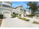 Townhome with two-car garage, landscaping, and inviting entryway at 2135 Park Crescent Dr, Land O Lakes, FL 34639
