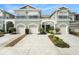 Attractive three-unit townhome building with attached garages and landscaping at 2135 Park Crescent Dr, Land O Lakes, FL 34639