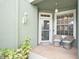 Cozy front porch with wicker chairs, inviting entryway, and landscaping at 2135 Park Crescent Dr, Land O Lakes, FL 34639