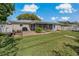 Backyard view showing patio, lawn, and screened porch at 2211 Morningside Dr, Clearwater, FL 33764