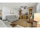 Bright living room featuring a built-in entertainment center and ceiling fan at 2211 Morningside Dr, Clearwater, FL 33764