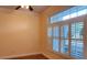 Bright bedroom with wood floors and large window with shutters at 25622 Ferdinand Ct, Wesley Chapel, FL 33544