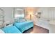 Twin bedroom with light blue bedding and coastal decor at 2589 Redwood Cir, Clearwater, FL 33763