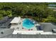 Community pool with surrounding lounge chairs and patio area at 2589 Redwood Cir, Clearwater, FL 33763