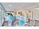 Bright dining area with glass table and blue chairs at 2589 Redwood Cir, Clearwater, FL 33763
