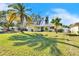 Ranch style home with palm trees and well-maintained lawn at 2589 Redwood Cir, Clearwater, FL 33763