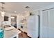 White kitchen with marble countertops and island at 2589 Redwood Cir, Clearwater, FL 33763