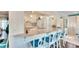 White kitchen features a breakfast bar with blue cushioned stools at 2589 Redwood Cir, Clearwater, FL 33763