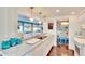Open kitchen with white cabinets and marble countertops at 2589 Redwood Cir, Clearwater, FL 33763