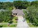 House with driveway and landscaped yard, aerial view at 2715 Durant Trails Blvd, Dover, FL 33527