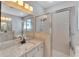 Bathroom with granite countertop, shower, and large mirror at 2715 Durant Trails Blvd, Dover, FL 33527