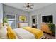 Virtually staged bedroom with large bed and yellow bedding at 2715 Durant Trails Blvd, Dover, FL 33527