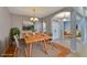 Virtually staged dining room with light walls and a wood dining table at 2715 Durant Trails Blvd, Dover, FL 33527