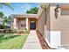 Front entrance with walkway, landscaping, and two dark-colored doors at 2715 Durant Trails Blvd, Dover, FL 33527