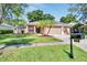 Tan house with a three-car garage and palm trees in the front yard at 2715 Durant Trails Blvd, Dover, FL 33527