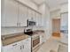 Updated kitchen featuring granite countertops and white cabinets at 2715 Durant Trails Blvd, Dover, FL 33527