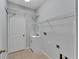 Laundry room with shelving, sink, and tiled floor at 2715 Durant Trails Blvd, Dover, FL 33527