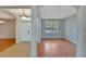 Open living room and entryway with wood flooring and neutral color palette at 2715 Durant Trails Blvd, Dover, FL 33527