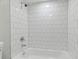 White tiled bathroom with a tub and shower at 3020 Deleuil Ave, Tampa, FL 33610
