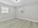 Bright bedroom with wood-look floors and neutral walls at 3020 Deleuil Ave, Tampa, FL 33610