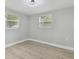 Bright bedroom with wood-look floors and neutral walls at 3020 Deleuil Ave, Tampa, FL 33610