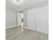 Bedroom with double closets and wood-look floors at 3020 Deleuil Ave, Tampa, FL 33610