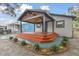 Updated home exterior with new landscaping and covered porch at 3020 Deleuil Ave, Tampa, FL 33610