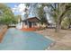 Charming house with a teal driveway and large trees at 3020 Deleuil Ave, Tampa, FL 33610