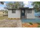 House exterior with dark door and landscaping at 3020 Deleuil Ave, Tampa, FL 33610