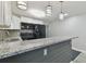 Modern kitchen with granite counters and dark cabinetry at 3020 Deleuil Ave, Tampa, FL 33610