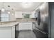 Modern kitchen with white cabinets, granite countertops, and stainless steel appliances at 3020 Deleuil Ave, Tampa, FL 33610