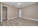 Bright bedroom with wood-look floors and ceiling fan at 3111 Bay Ln, Clearwater, FL 33759