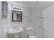 Clean bathroom featuring a vanity sink, a toilet, and a shower with white subway tile at 3205 Moog Rd, Holiday, FL 34691