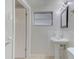 Bathroom with a pedestal sink, and white subway tile surround, and a window with natural light at 3205 Moog Rd, Holiday, FL 34691