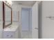 Bathroom featuring a modern vanity with a sink, and a view into the hallway at 3205 Moog Rd, Holiday, FL 34691
