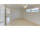 Well-lit bedroom featuring tile flooring, a ceiling fan, and natural light streaming through the window at 3205 Moog Rd, Holiday, FL 34691