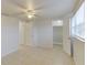 Bright bedroom with a ceiling fan, tile flooring, and a walk-in closet for ample storage at 3205 Moog Rd, Holiday, FL 34691