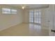 Bedroom featuring tile flooring, large windows, and an access door to the screened in porch at 3205 Moog Rd, Holiday, FL 34691