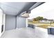 Covered patio featuring neutral paint with a view of the neighborhood street at 3205 Moog Rd, Holiday, FL 34691
